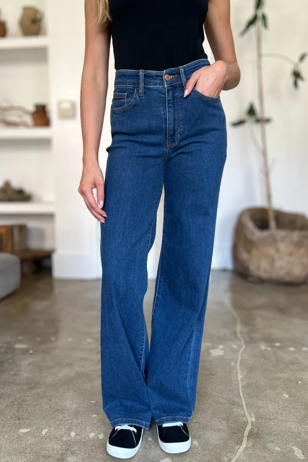 Medium blue high rise straight jeans, relaxed straight leg in back view
