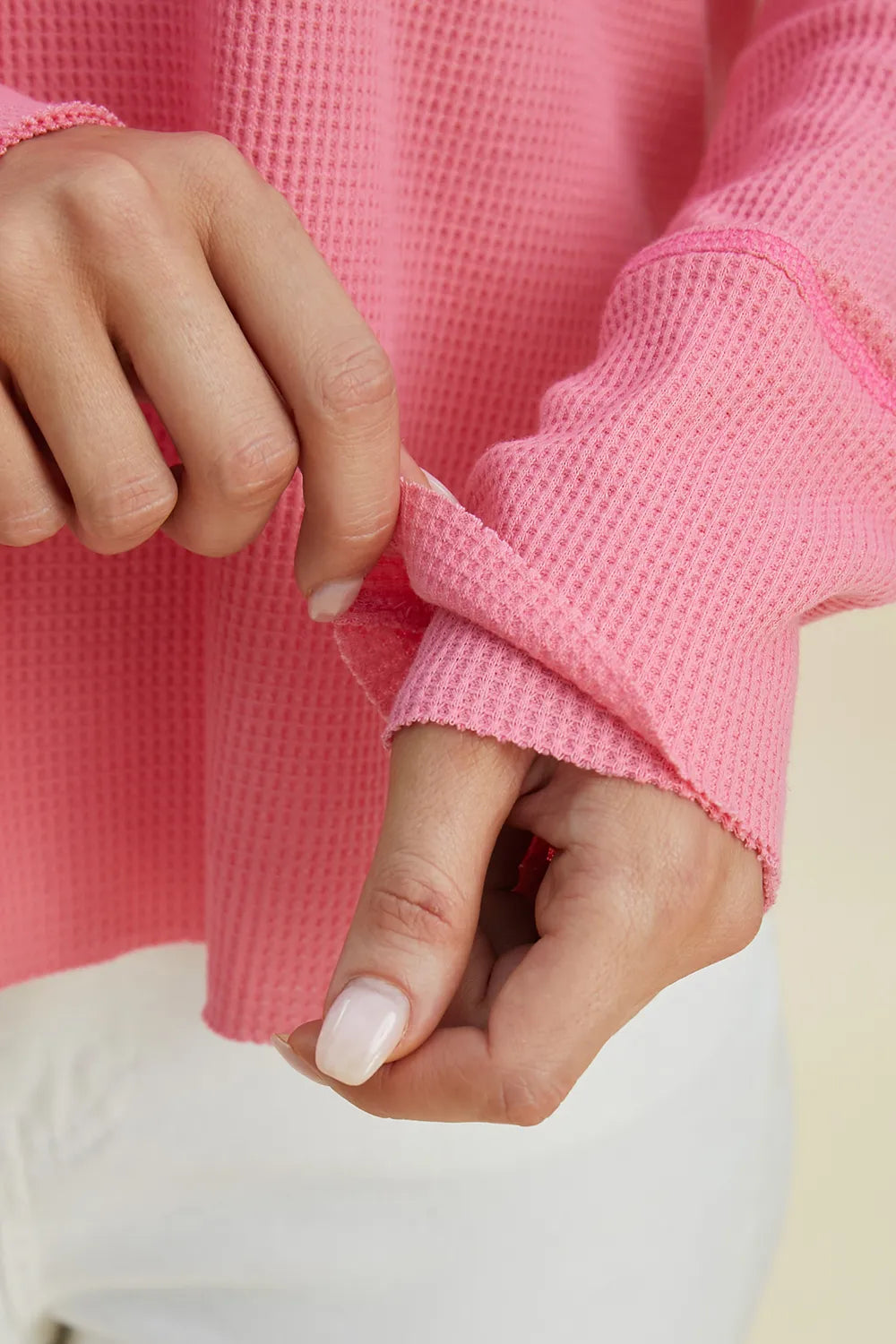 Pink hoodie sleeve cuff detail with waffle-like texture