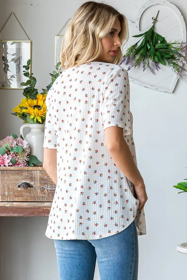Babydoll top in white ditsy floral print, short sleeves, gathered peplum hem