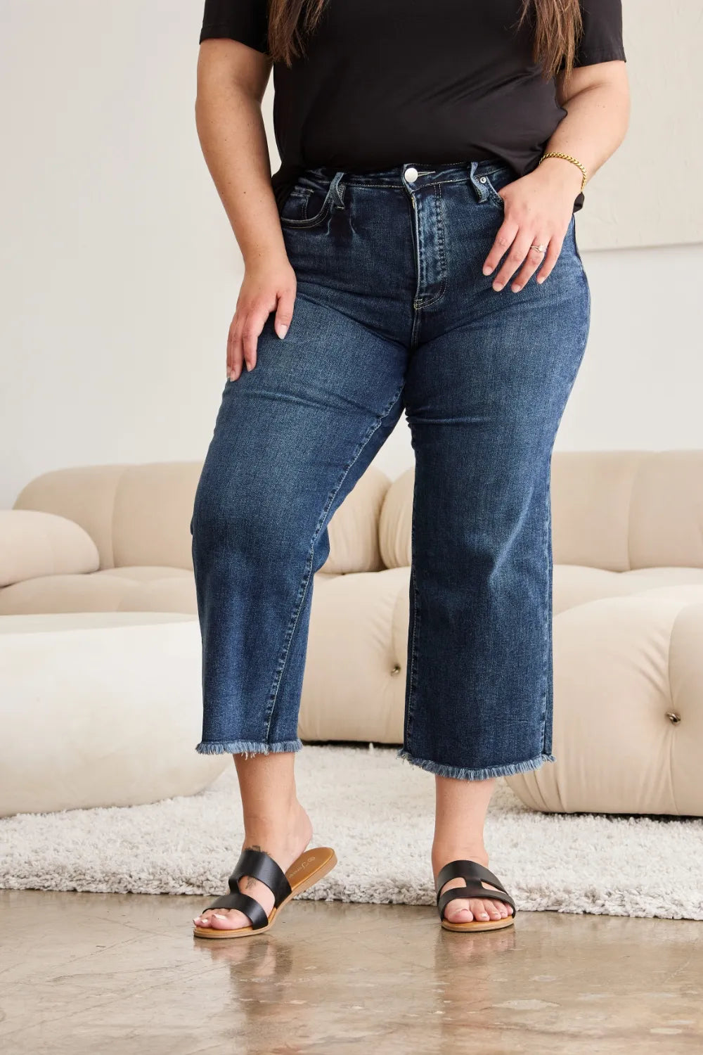 Straight fit high-waist jeans with raw cuffs and dark wash distress on thighs