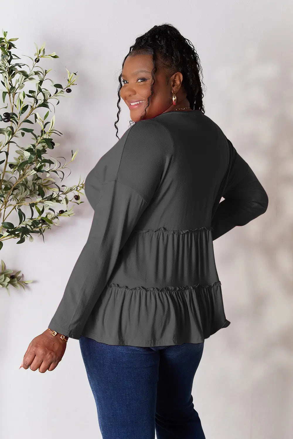 Dark gray long-sleeve blouse with tiered ruffle back hem and gathered waist
