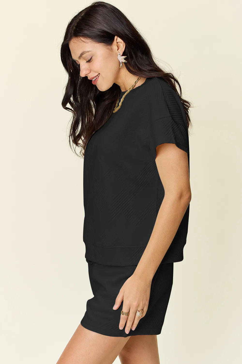 Black short-sleeve textured T-shirt and drawstring shorts set, side view