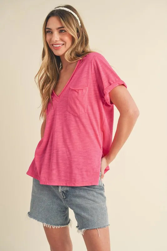 Hot pink V-neck T-shirt, short rolled sleeves, chest pocket and side slit