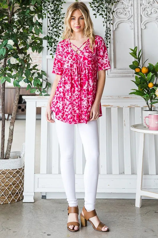 Hot pink animal-print babydoll tunic top with crisscross V-neck and short sleeves