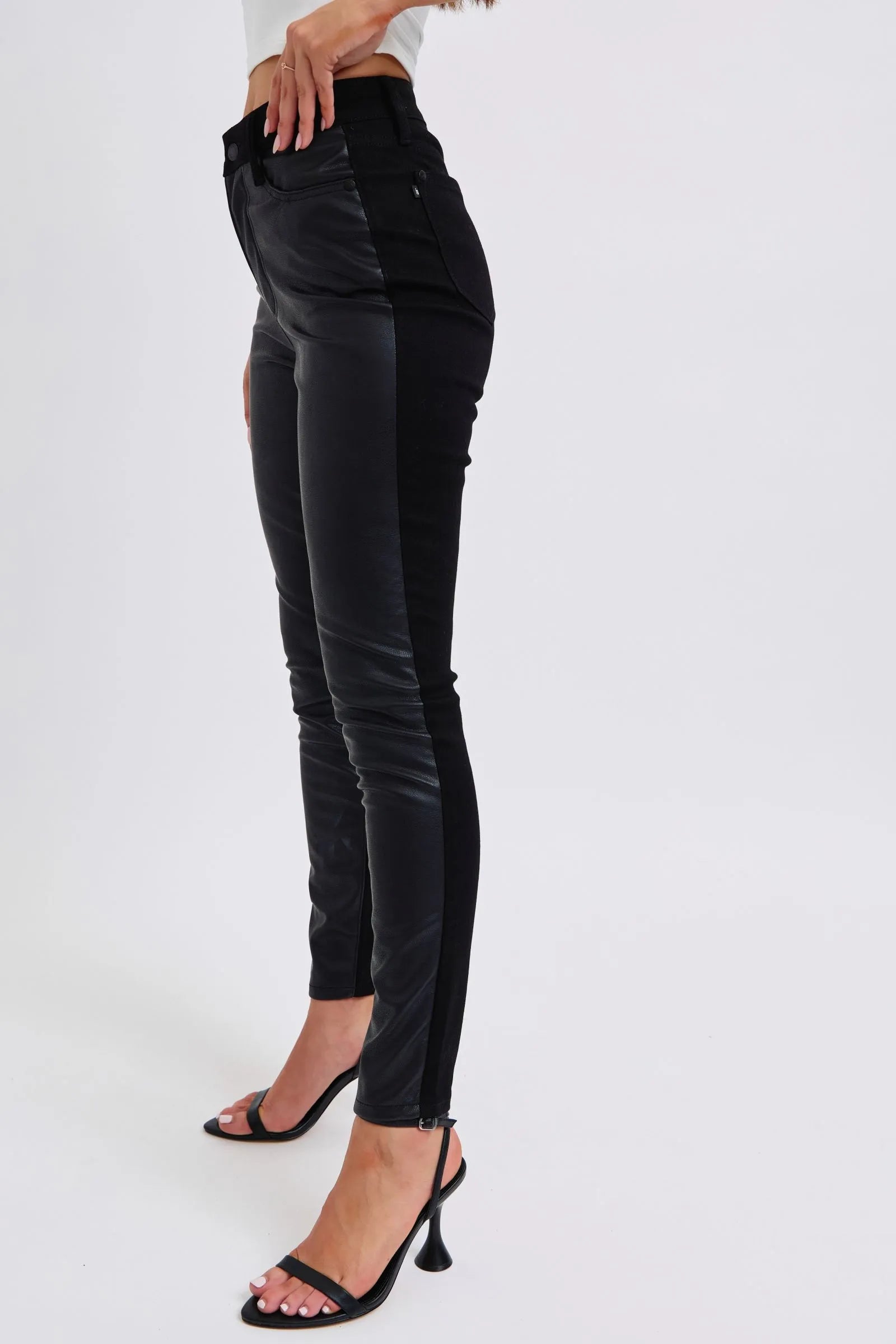 Plus size faux leather skinny pants in black, side profile, zip fly and pockets