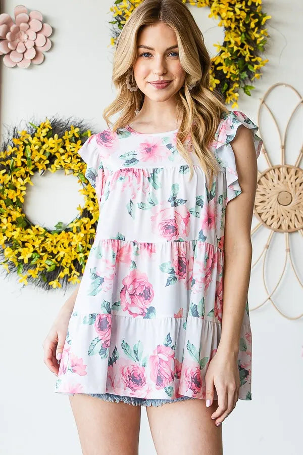 Cream floral tiered round-neck top with ruffled cap sleeves, front view