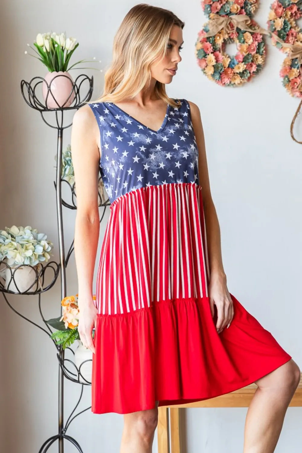 Sleeveless tank dress side view: blue star bodice and flowing red striped skirt