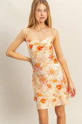 Floral satin mini dress with cowl neckline, orange-and-cream bouquet print, thin straps
