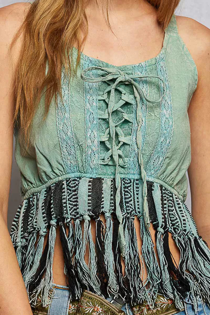 Close-up: sage lace-up tank with detailed lace panel and tassel fringe hem