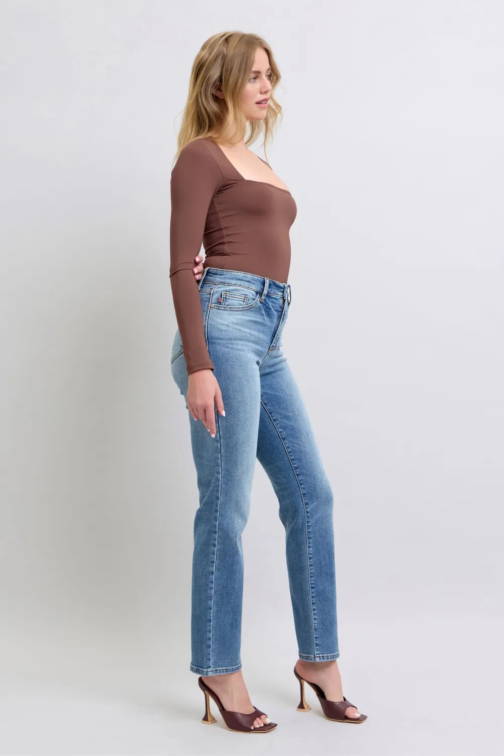 Front angle medium-wash vintage straight jeans with belt loops and button fly
