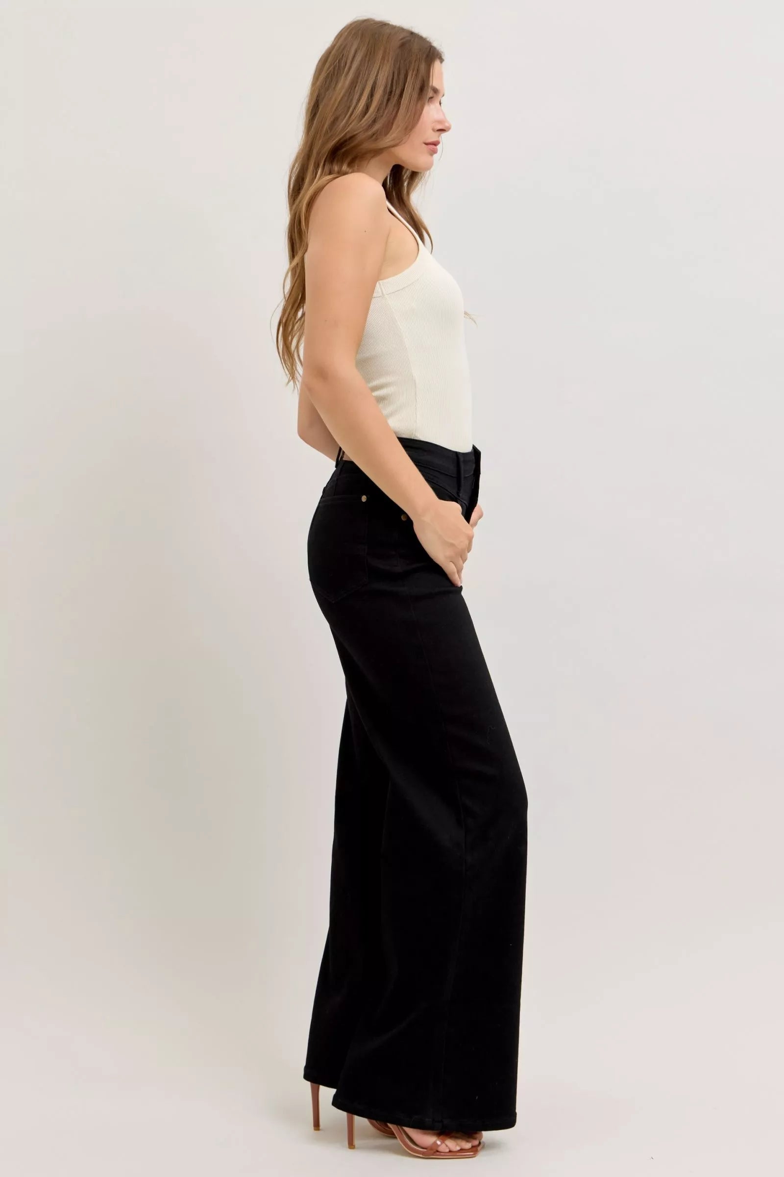 Back/side view of black high-waisted wide-leg jeans with ankle-length hem