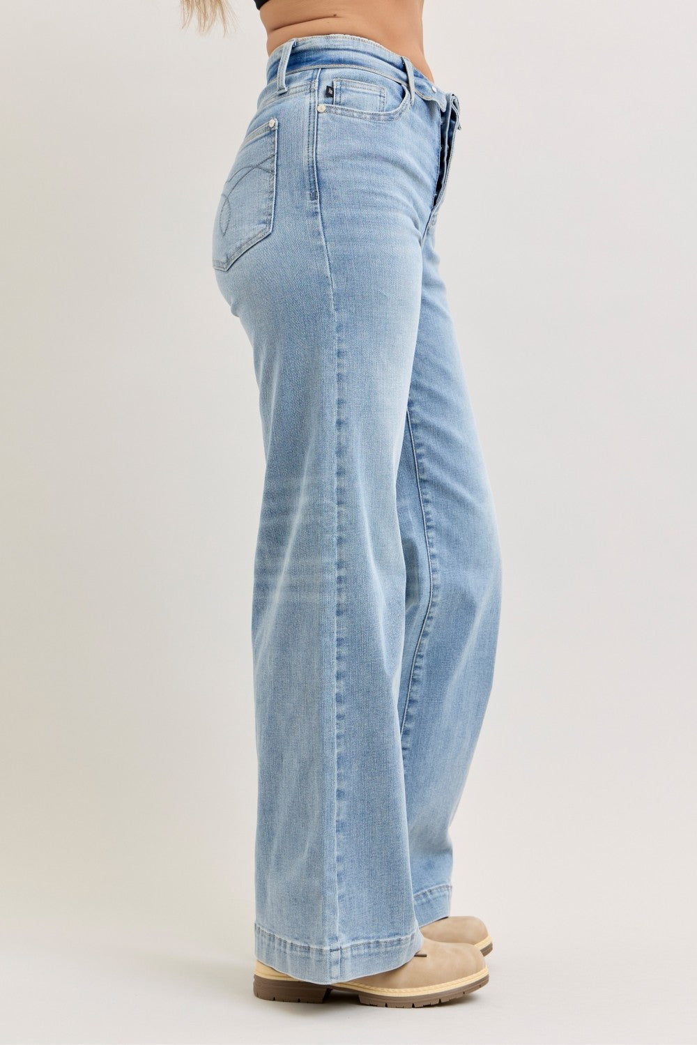 Light wash wide-leg jeans, side view, mid-rise with belt loops and button