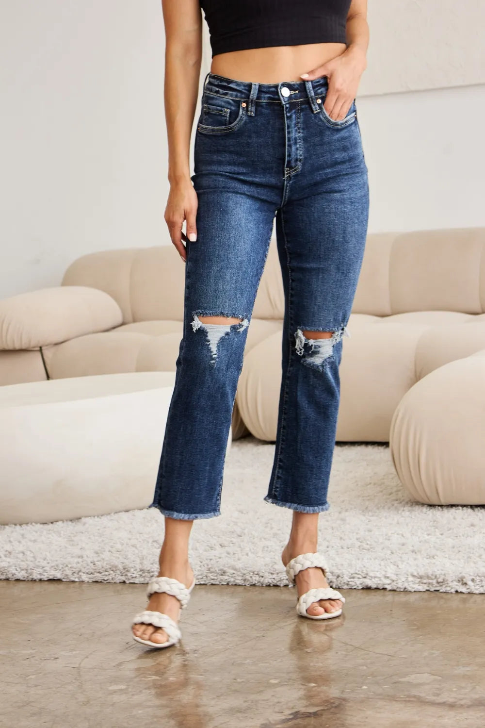 RFM high-waist jeans with raw hem, distressed knees, dark wash