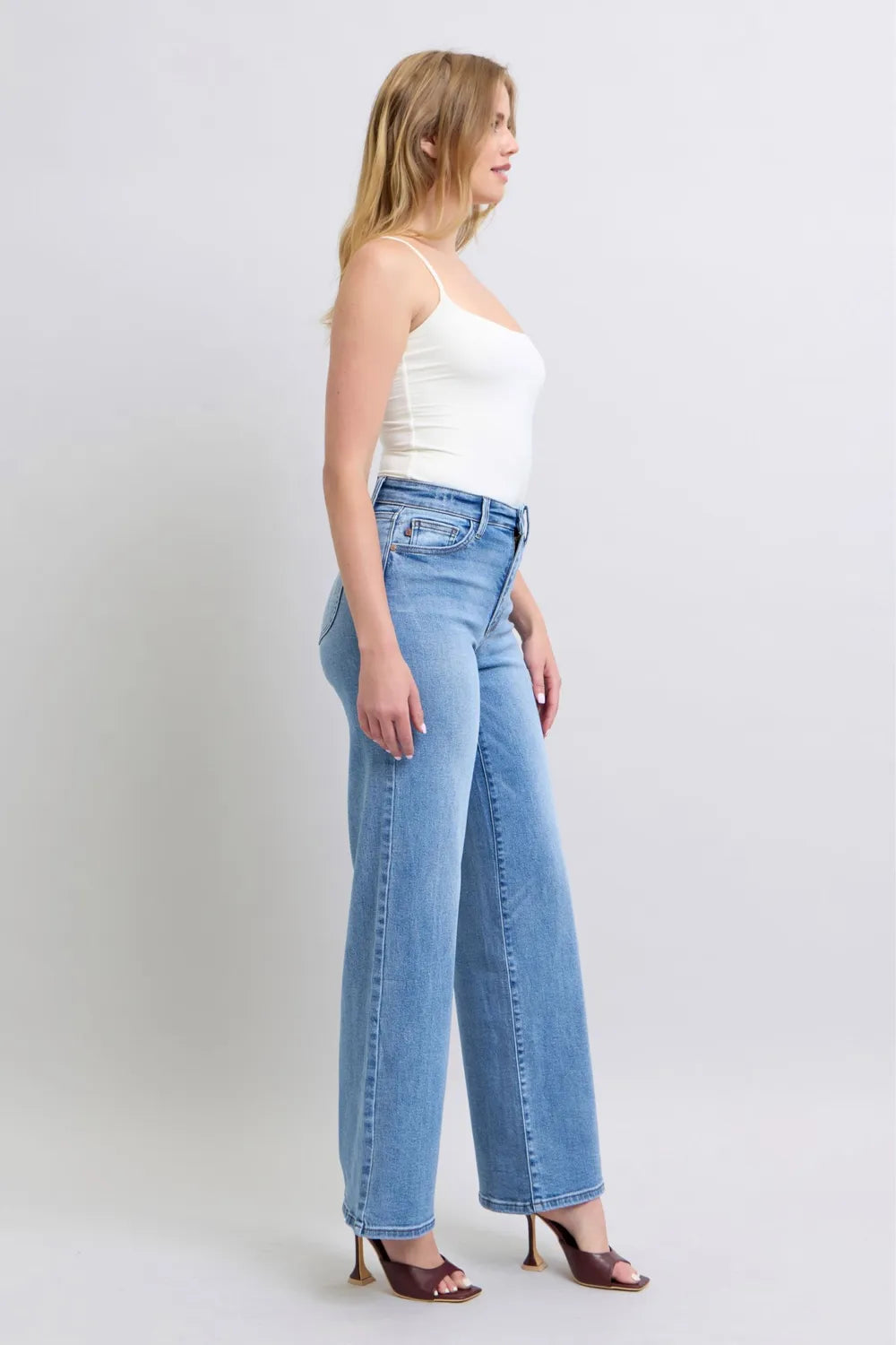 Medium-wash wide-leg denim jeans, front view with pockets and belt loops