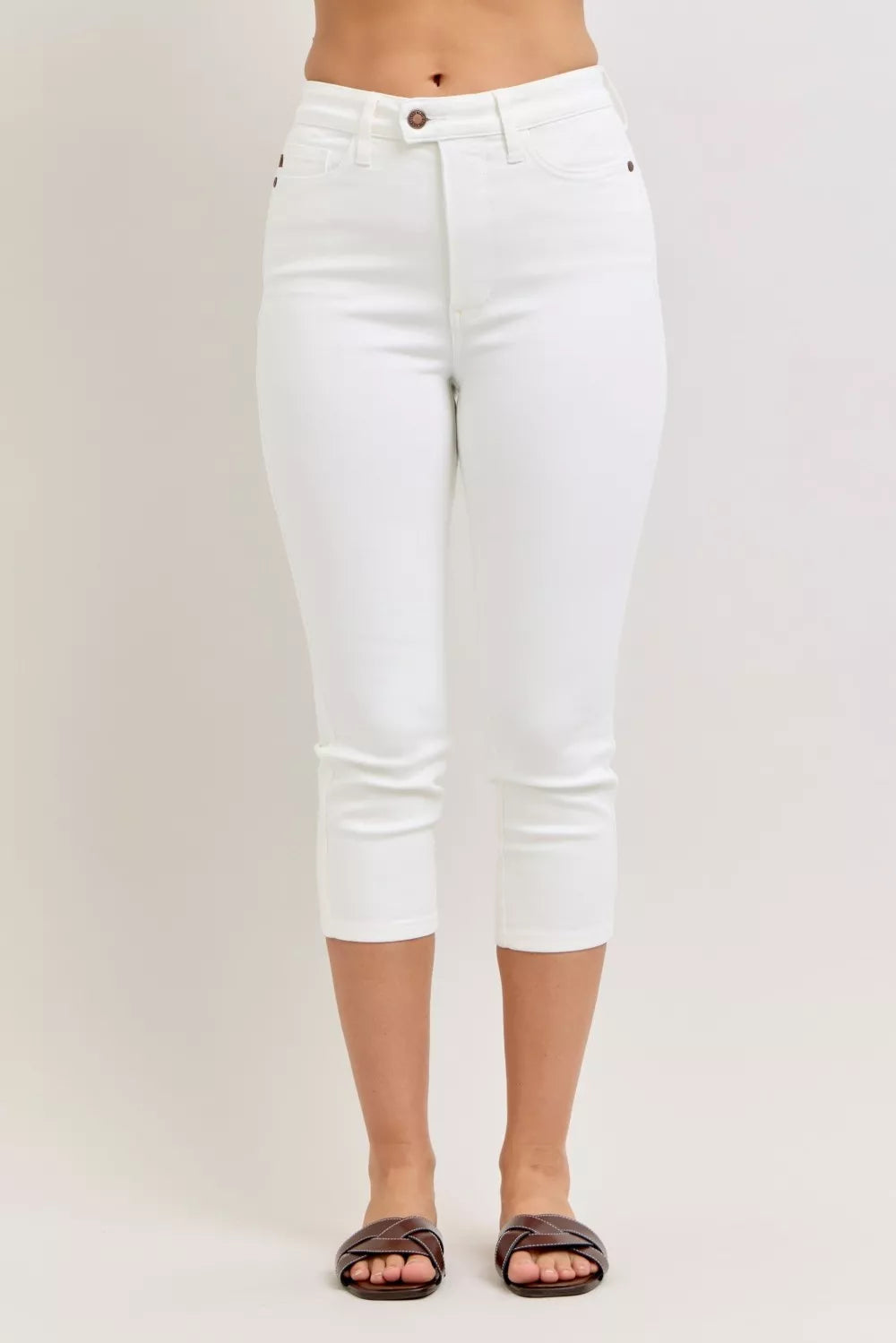 White high-waist capri jeans with extended waistband and spade front pockets