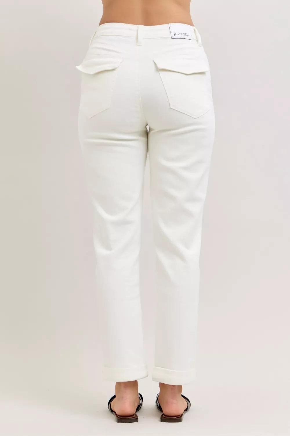 White high-waist jeans with roomy patch pockets and ankle-length hem