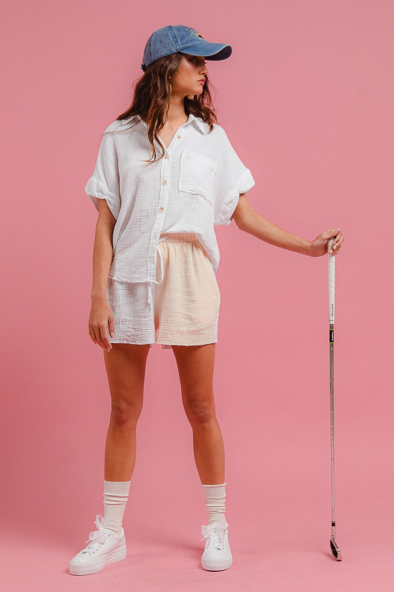 Side view of off-white wrinkled gauze shirt and drawstring shorts set, relaxed fit