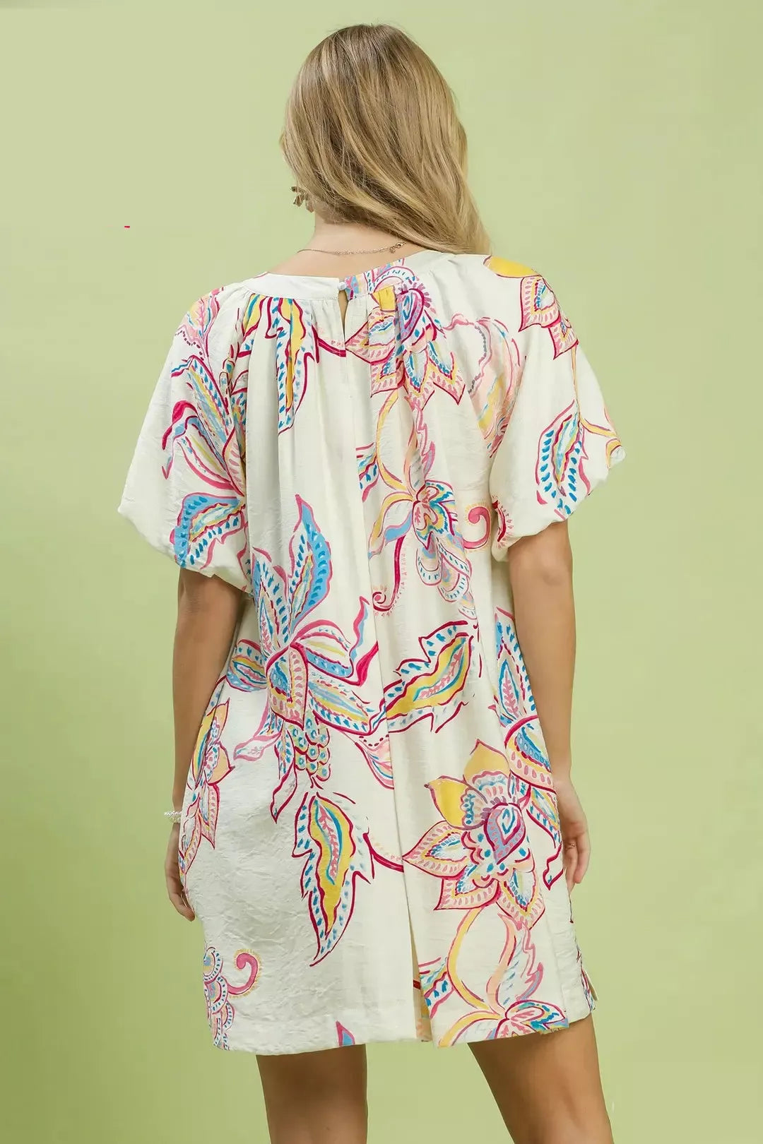 Back view: off-white boho floral mini dress with gathered yoke and short sleeves