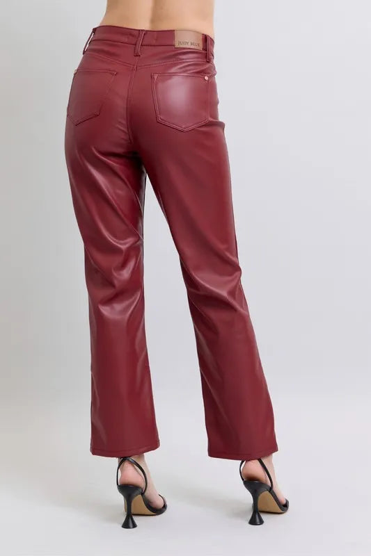 Red high-waist faux leather straight pants, back view with waistband and pocket seams