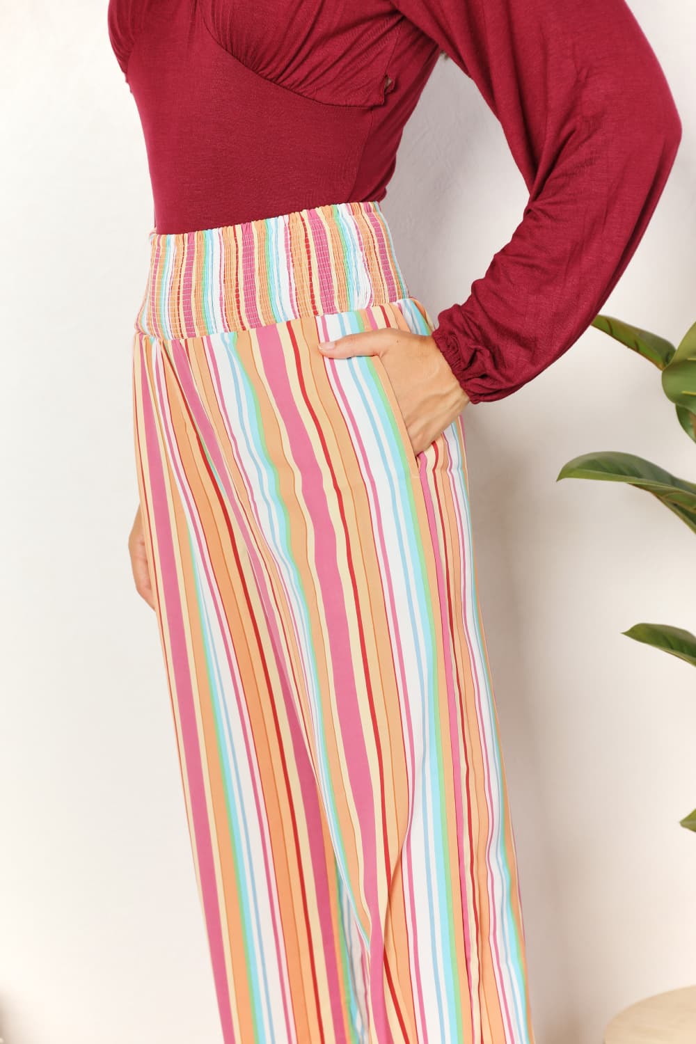 Close-up: multicolor striped smocked waistband and high-rise pant legs