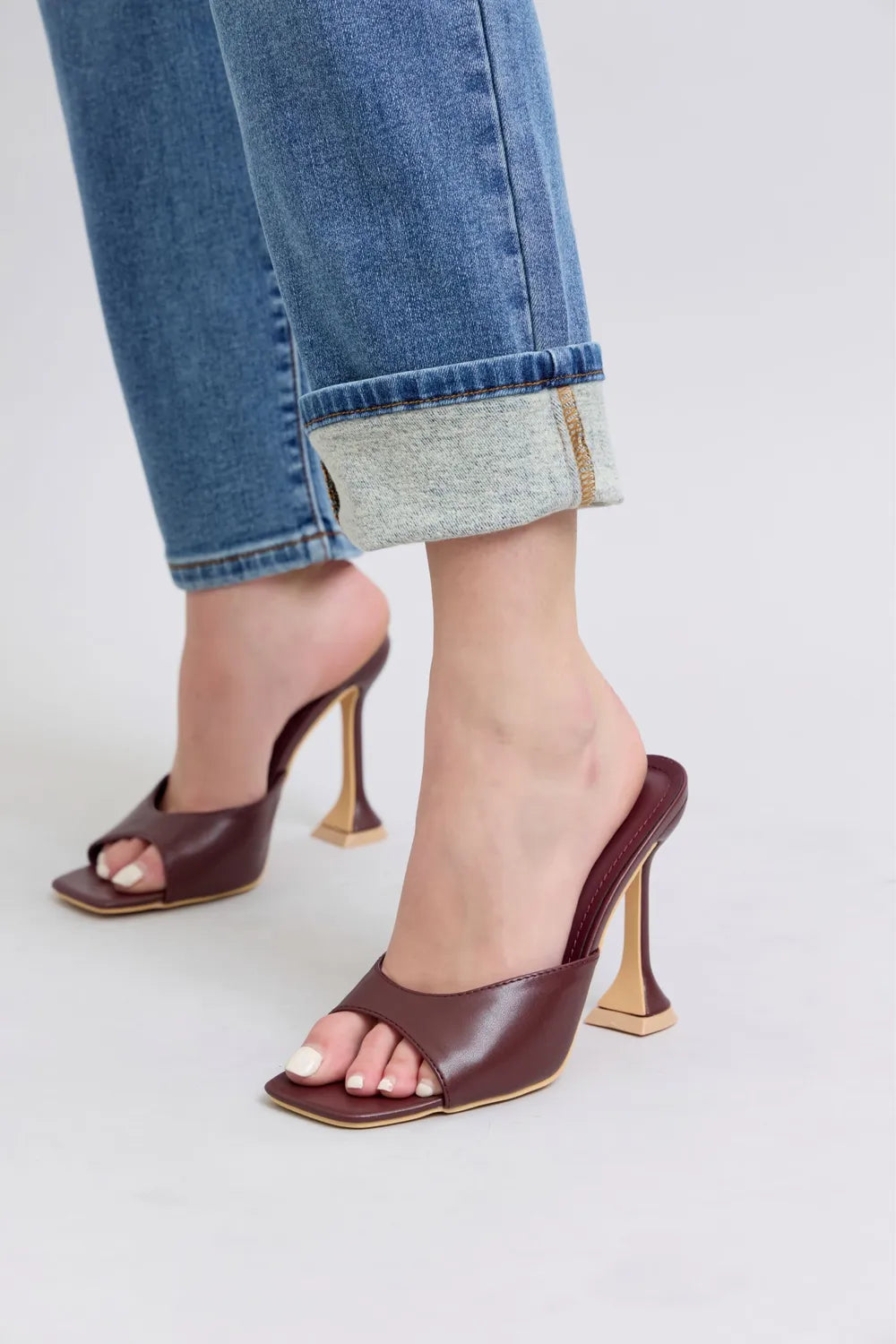 Cuffed medium-wash jean hem with visible stitched border