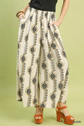 Wide-leg boho pants in cream with black geometric print, elastic waist and drawstring tie