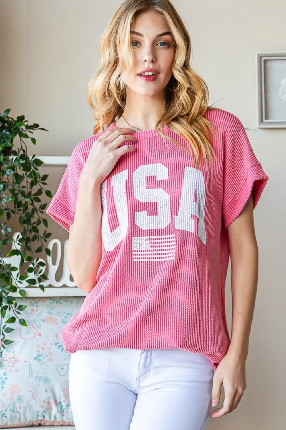 Coral ribbed short-sleeve top with crew neck and bold white USA front graphic