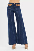 High-rise wide flare jeans in dark blue with front leather pocket detail