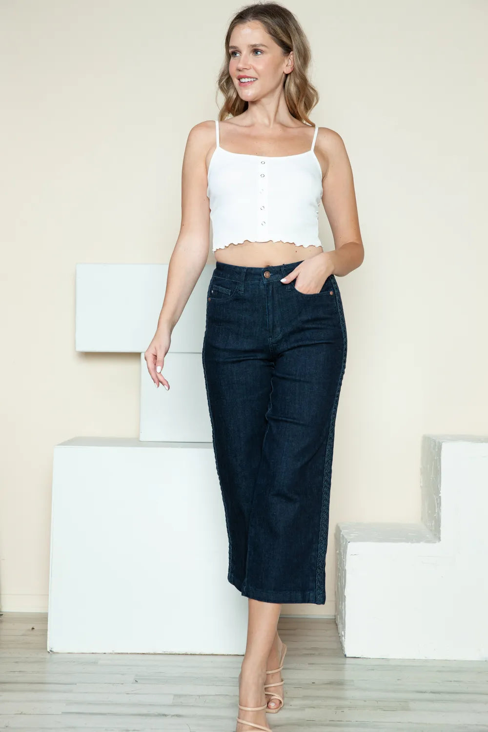 Dark wide-leg crop jeans, front button closure and braided side seam detail
