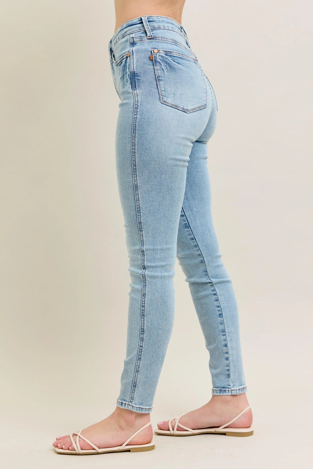 Light wash skinny jeans, side view, slim fit with front pocket and tapered hem