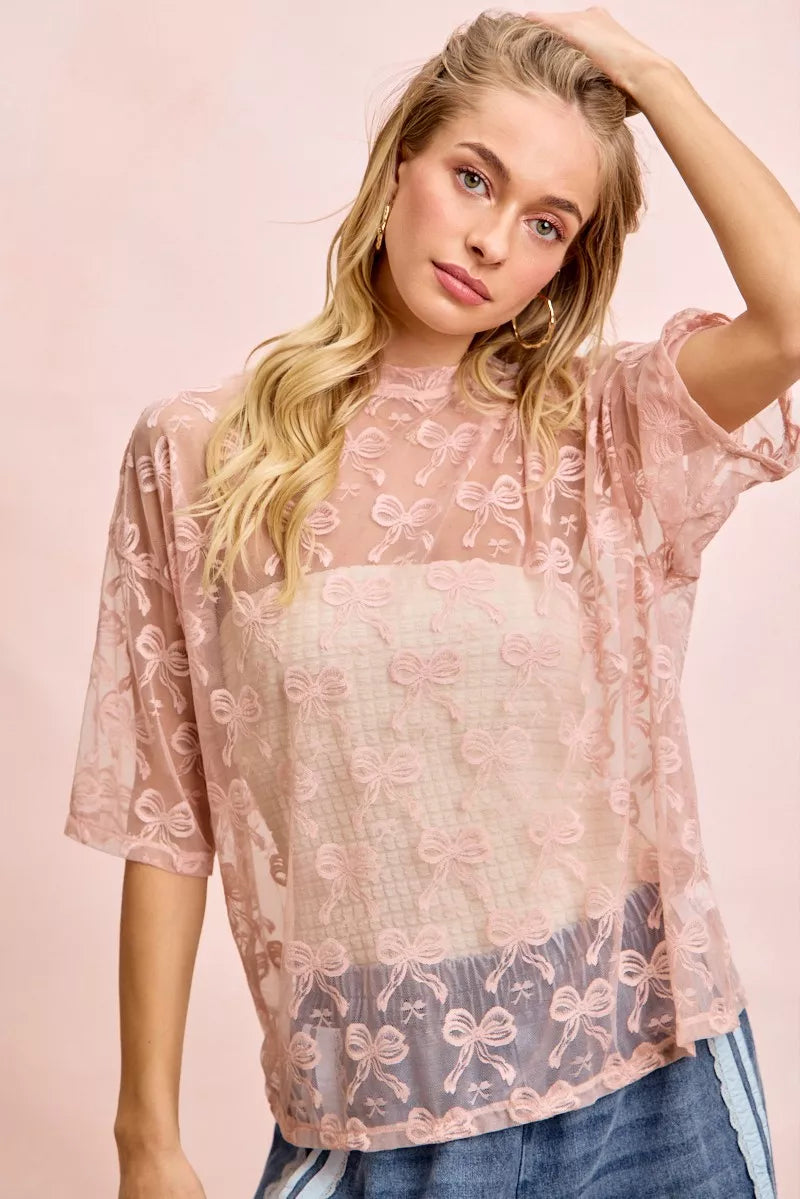 Dusty rose mesh top with bow pattern, boxy short sleeves and round neckline